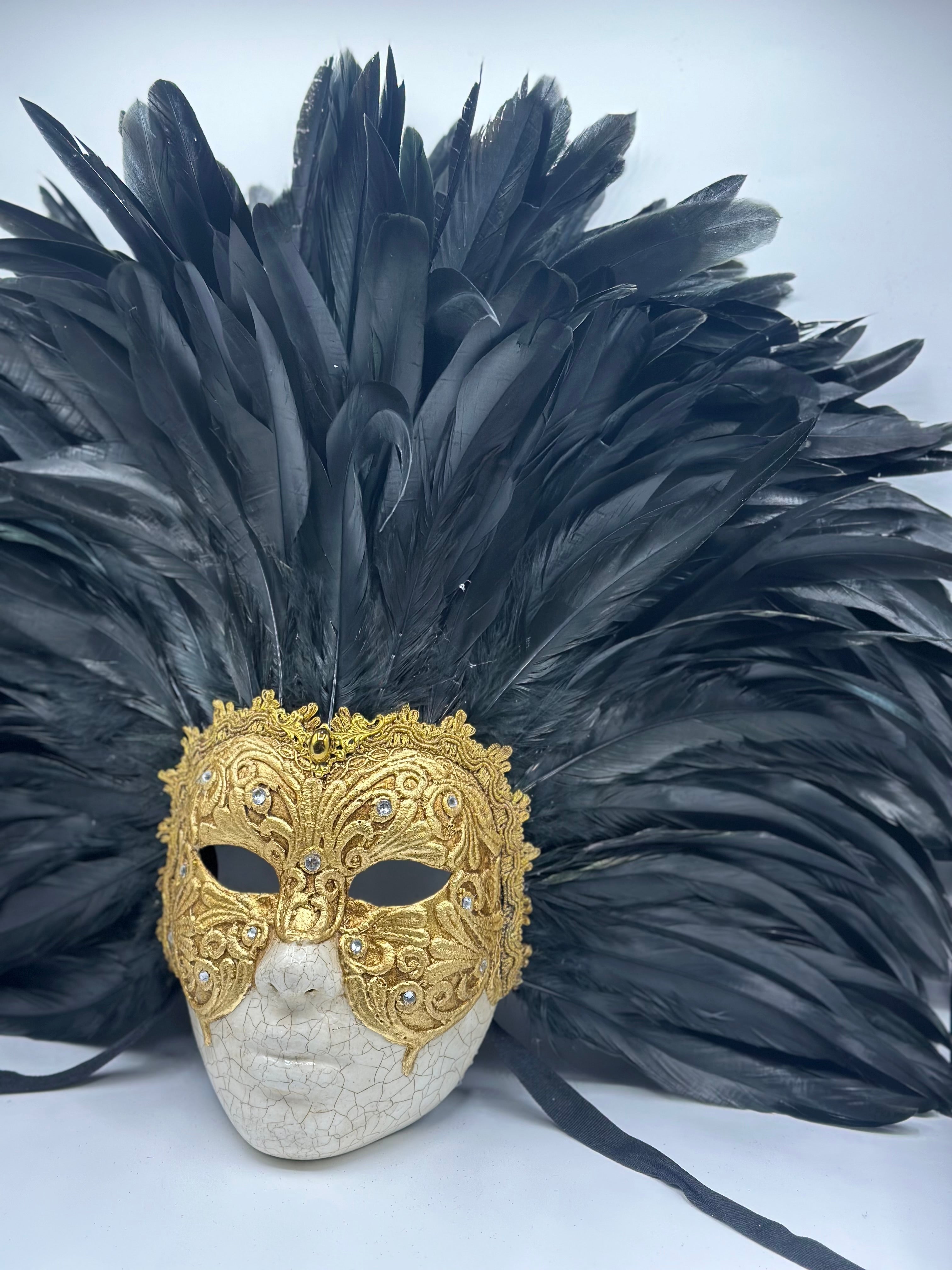 Full-face golden Venetian mask with black feathers