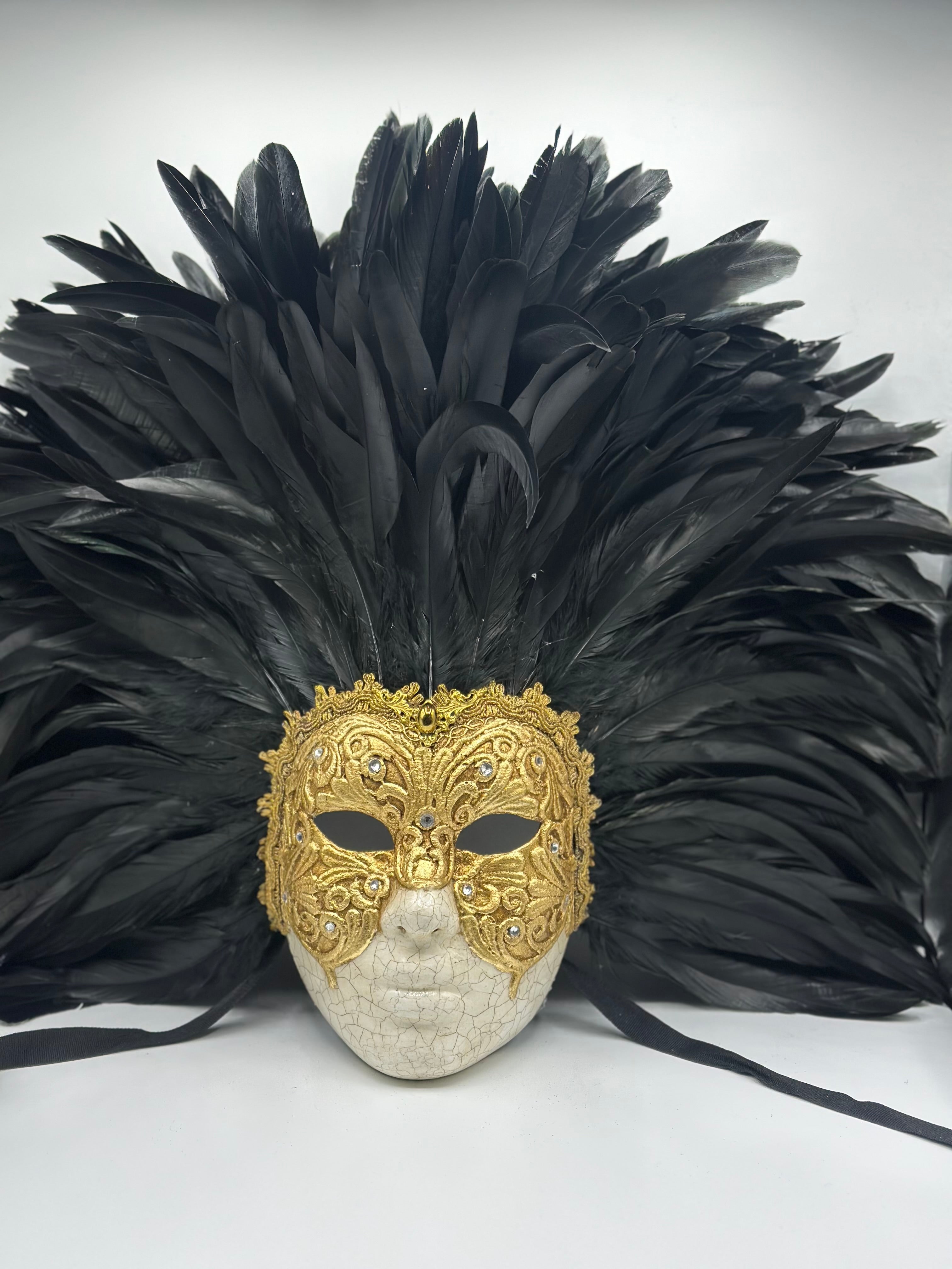 Full-face golden Venetian mask with black feathers